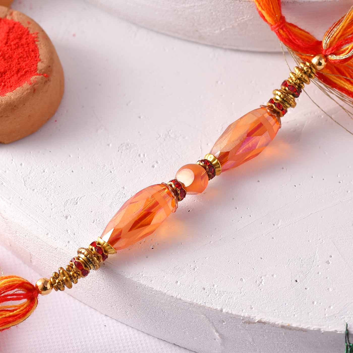 Premium Orange Beads Rakhi With Mauli Dori- 12 Pcs Pack