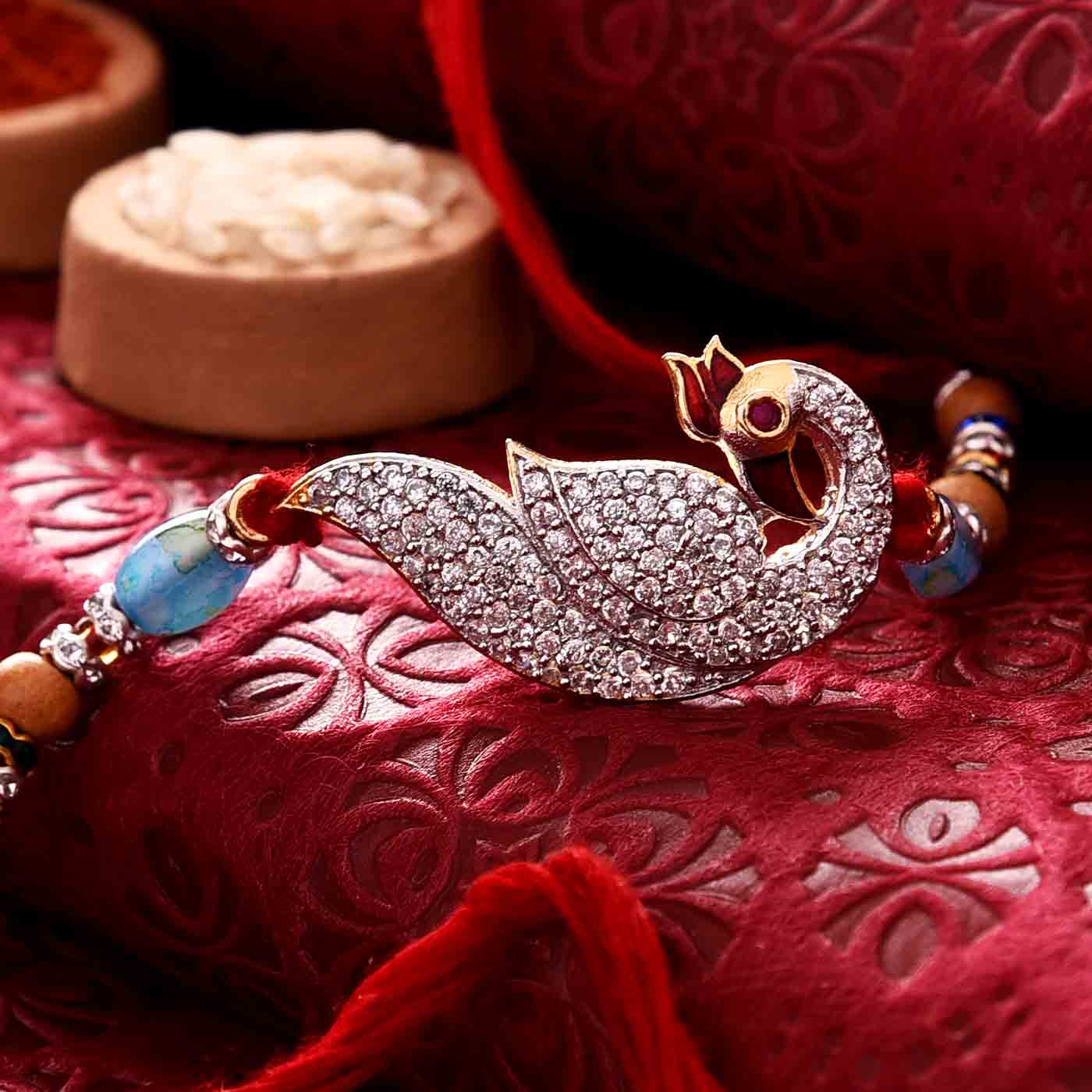 Glittering Stone Studded Peacock Rakhi - 12 Pcs Pack