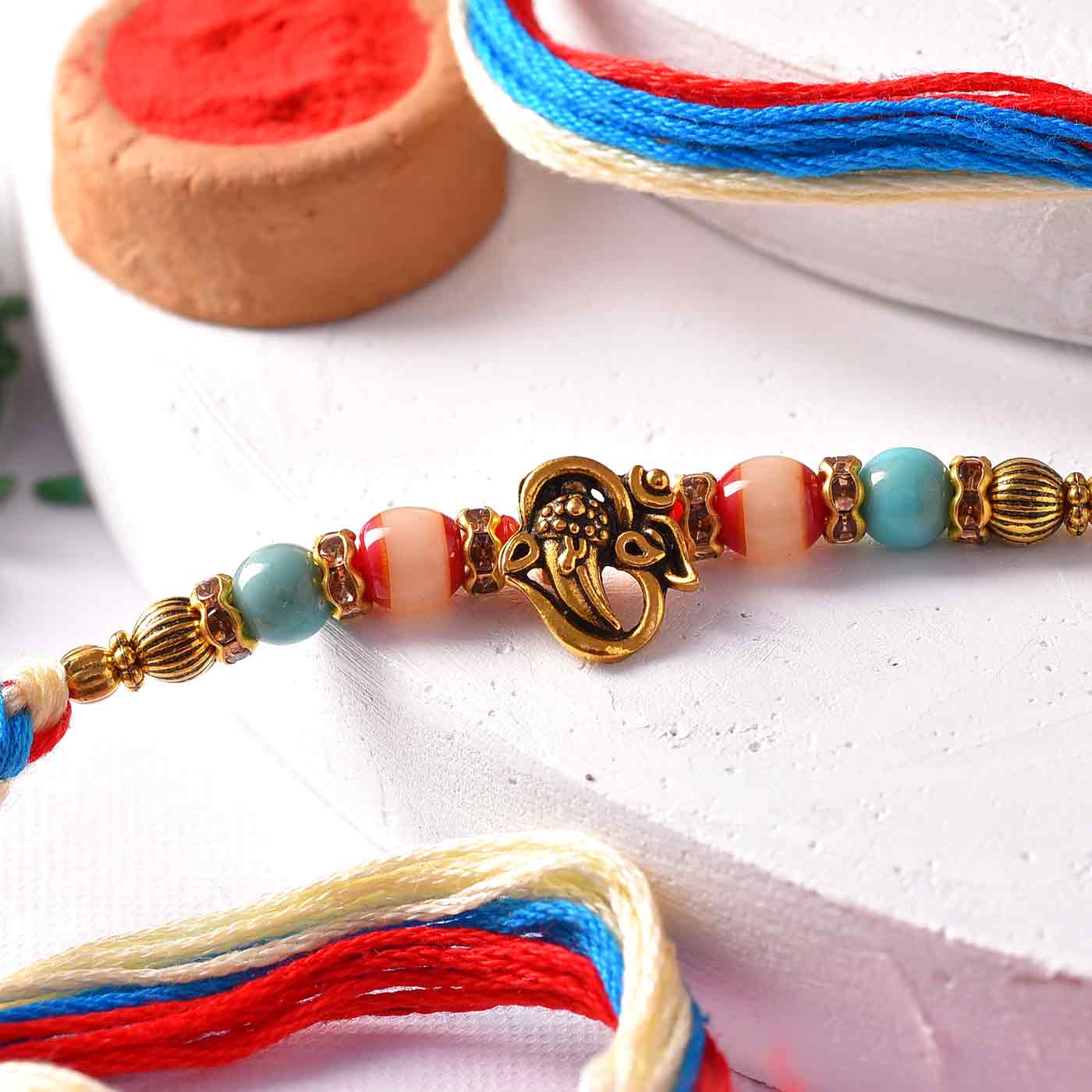 Designer Om Colourful Rakhi - 12 Pcs Pack