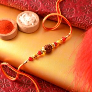Ethnic Rudraksha Rakhi Thread With Yellow Om & Red Beads- 12 Pcs Pack