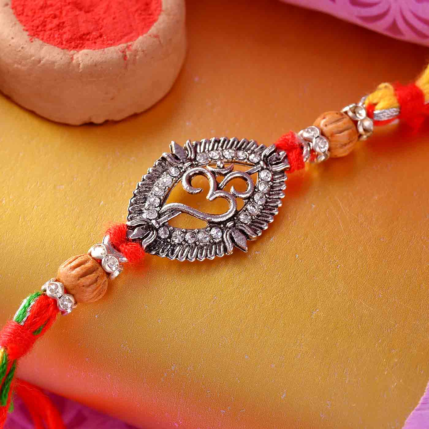 Divine Om Beads Rakhi With Antique Finish- 12 Pcs Pack