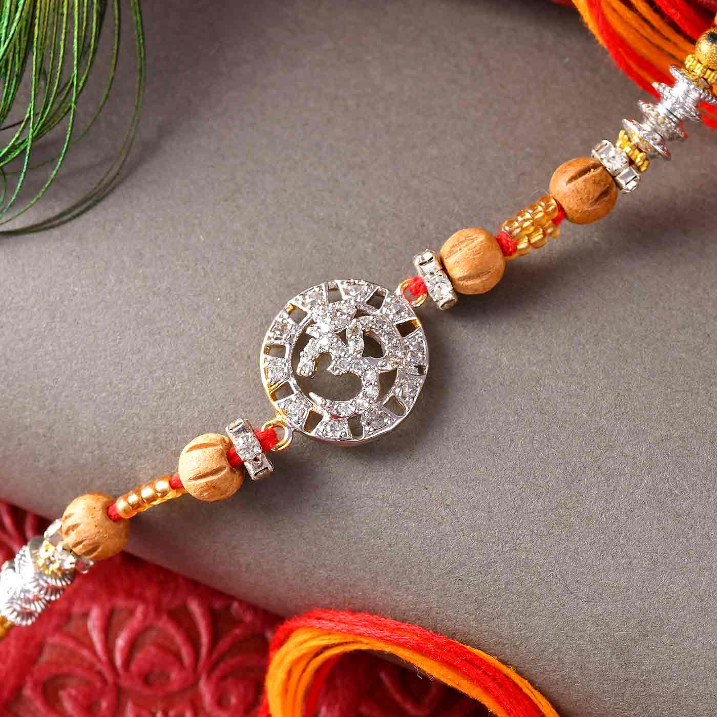 Traditional Stones Work Om & Wooden Beads Rakhi - 12 pcs Pack