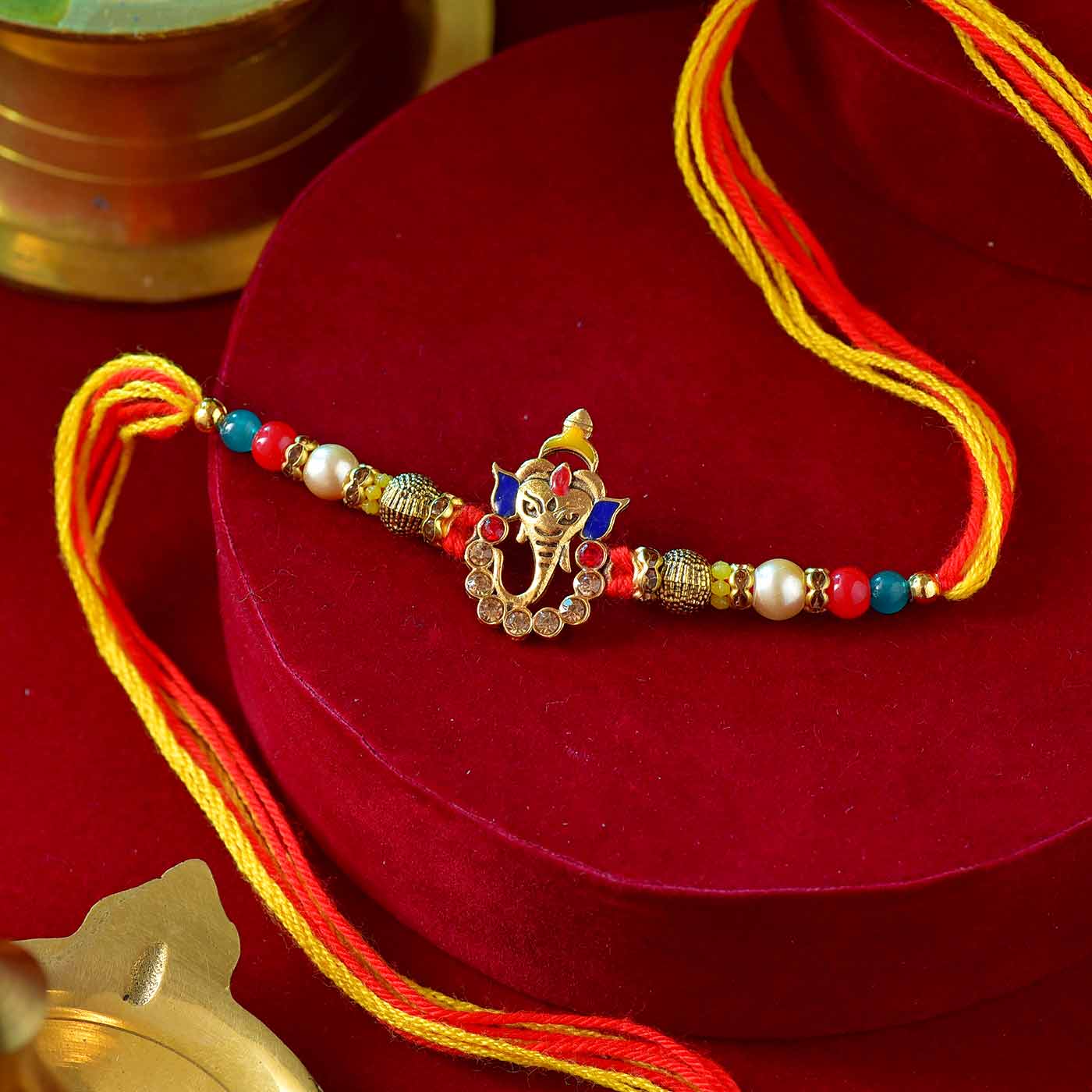 Auspicious Ganesha Rakhi With Colorful Pearls - 12 Pcs Pack