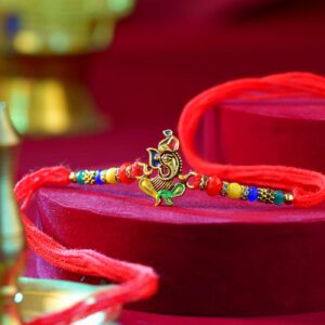 Sacred Ganesha Rakhi With Colorful Pearls - 12 Pcs Pack