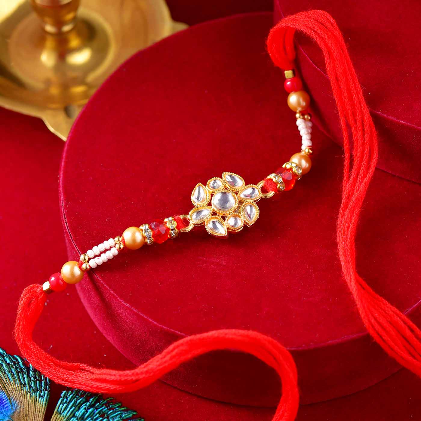 Floral Kundan Rakhi With Pearls & Mauli Dori - 12 Pcs Pack