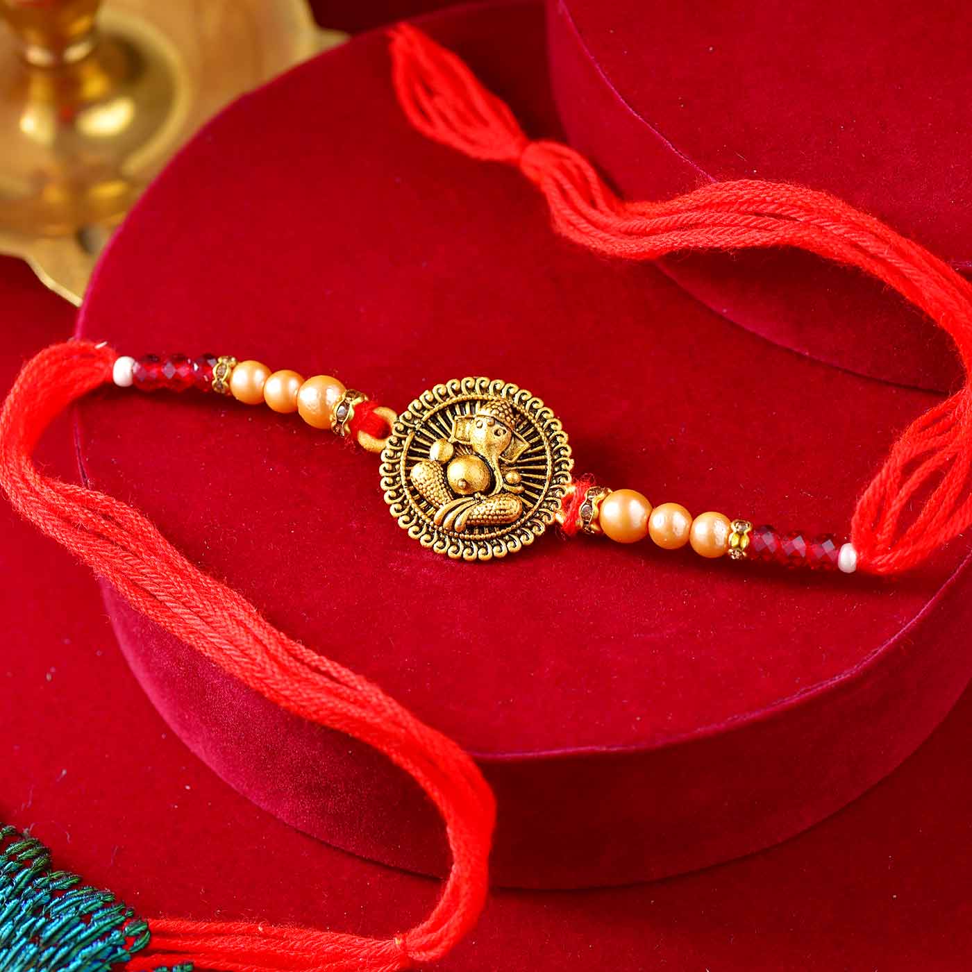 Golden Ganesha Dial Rakhi With Mauli Dori - 12 Pcs Pack