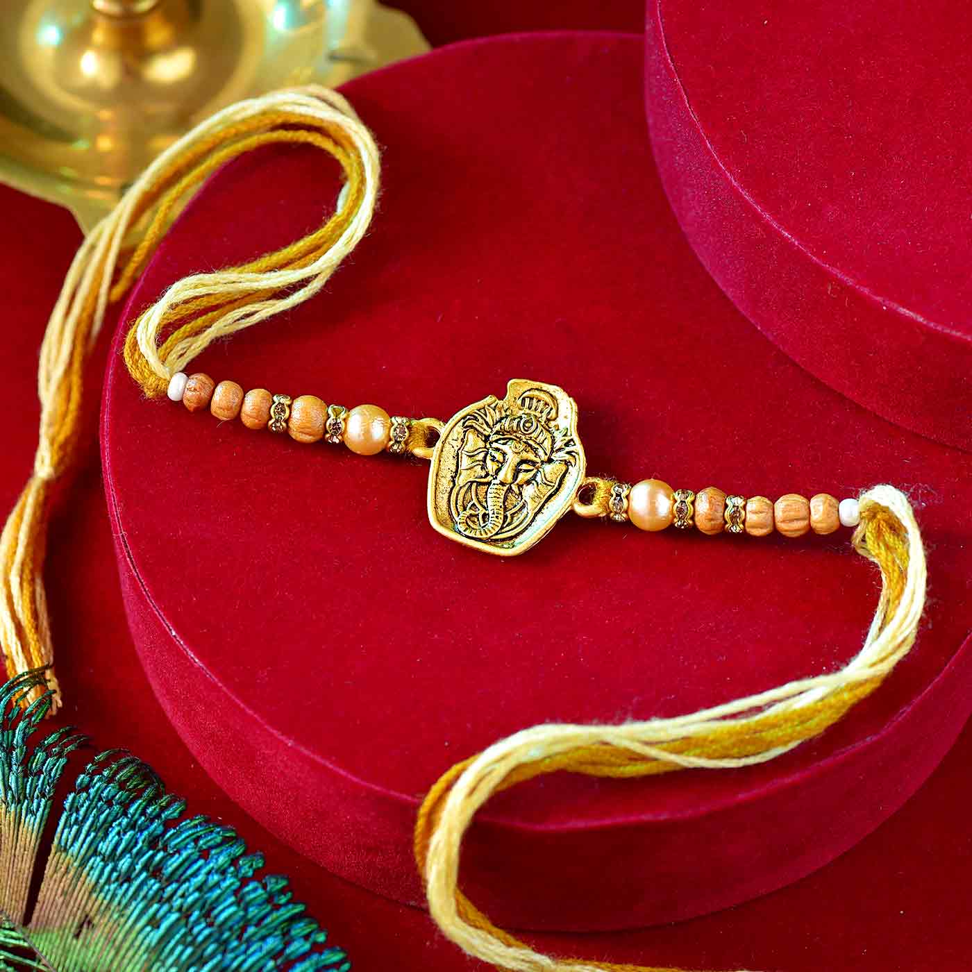 Golden Ganesha Rakhi With Pear & Beads - 12 Pcs Pack