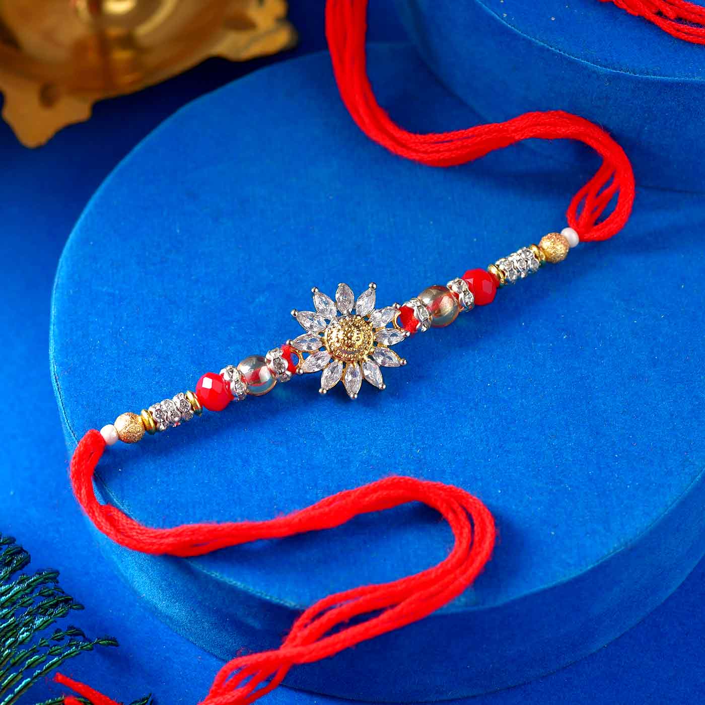 Floral AD Rakhi With Colorful Pearls & Mauli Dori - 12 Pcs Pack