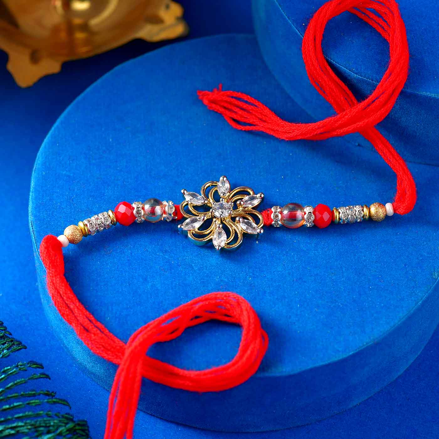 Striking Floral AD Rakhi with Red Pearls - 12 Pcs Pack