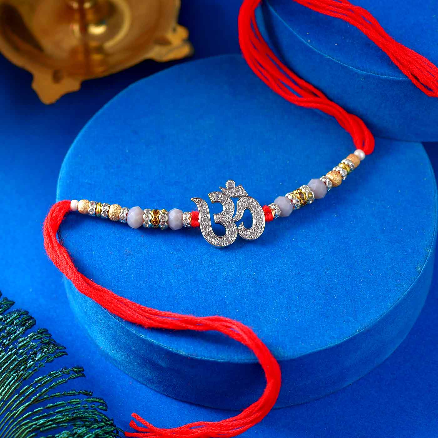 Gorgeous Om AD Rakhi With Pearls & Golden Beads - 12 Pcs Pearl Rakhi