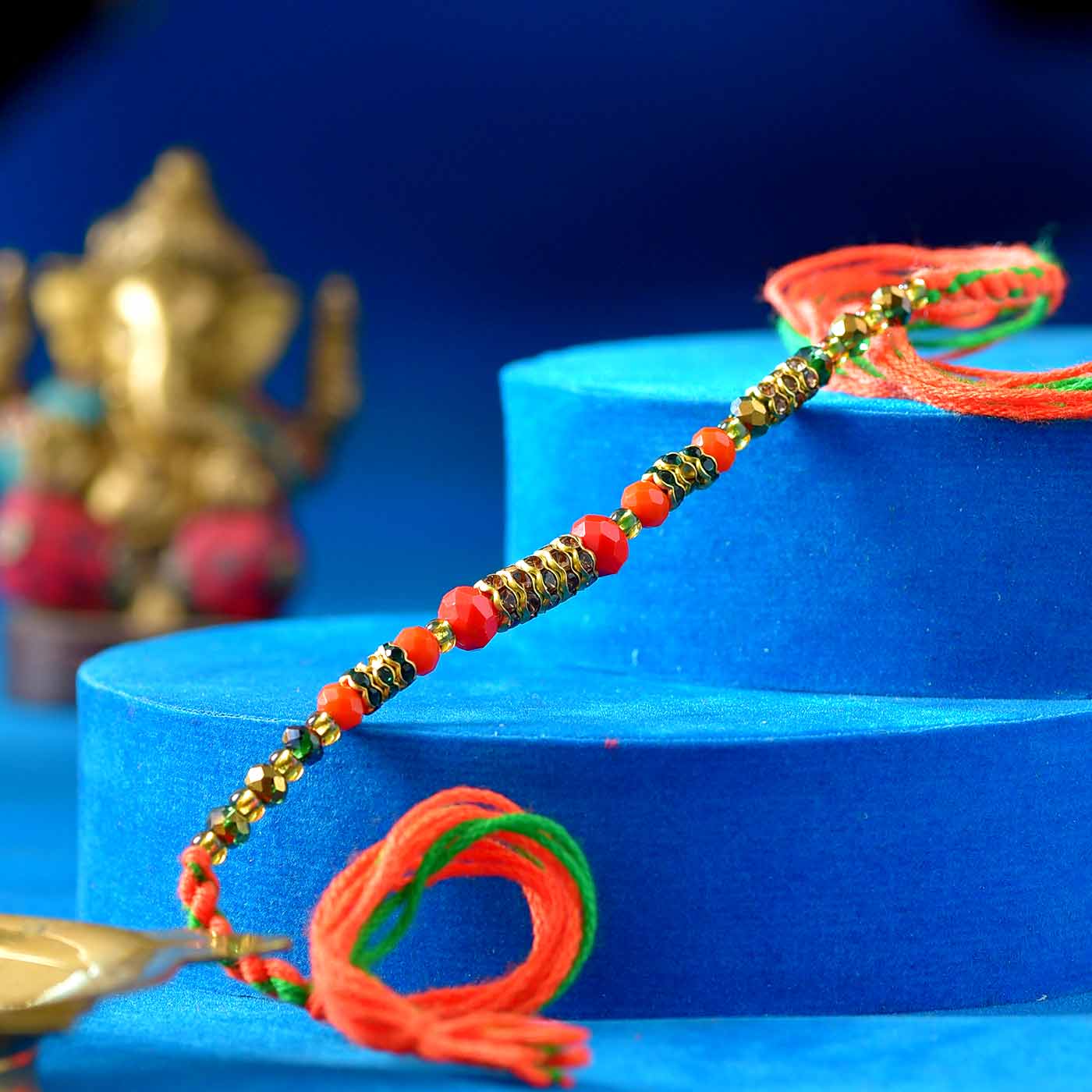 Traditional Orange Pearls & Glittering Stones Rakhi - 12 Pcs Pack
