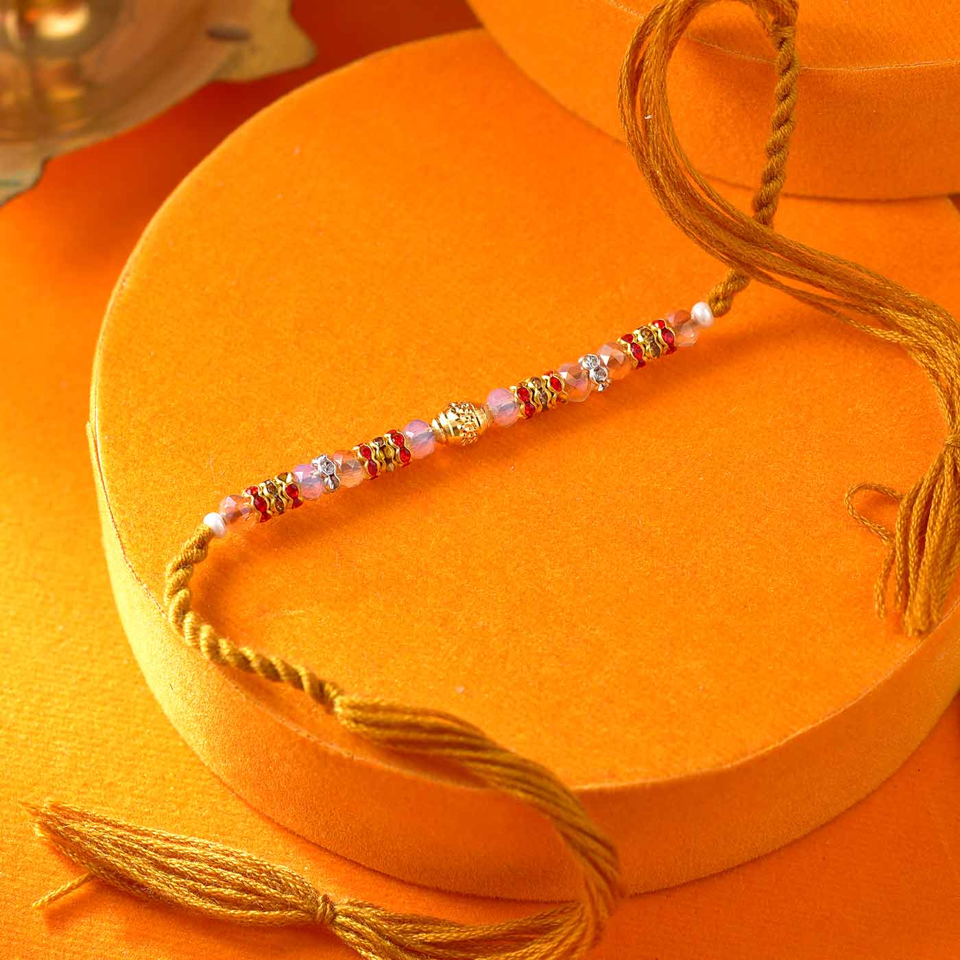 Dazzling Golden Pearl & Stone Rakhi - 12 Pcs Pack