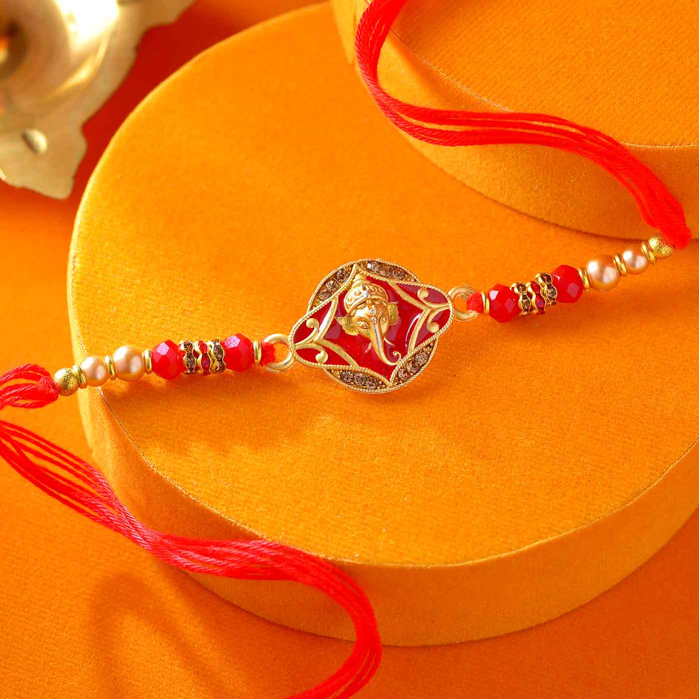 Divine Ganesha Red & Golden Pearl Rakhi - 12 Pcs Pack
