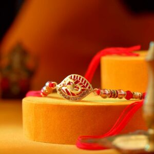 Auspicious Ganesha Rakhi Designed with Pretty Red Pearls - 12 Pcs Pack